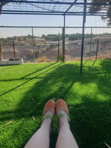 a person with their feet up on a soccer field at חצבים על הואדי in Arad