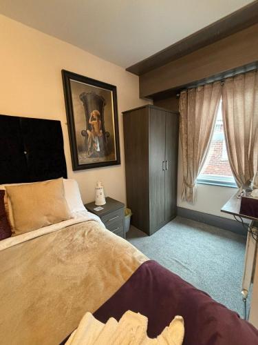 a bedroom with a large bed and a window at Kings Boutique Hotel in Blackpool
