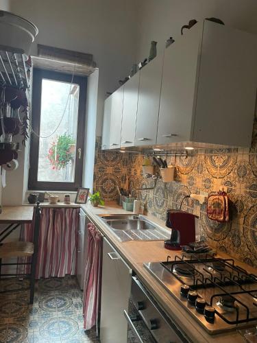 a kitchen with a sink and a stove top oven at Residenza del Castello di Fornelli in Fornelli