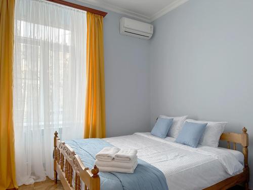 a bedroom with a bed with towels on it at Your Cascade Home: In Yerevan Heart in Yerevan