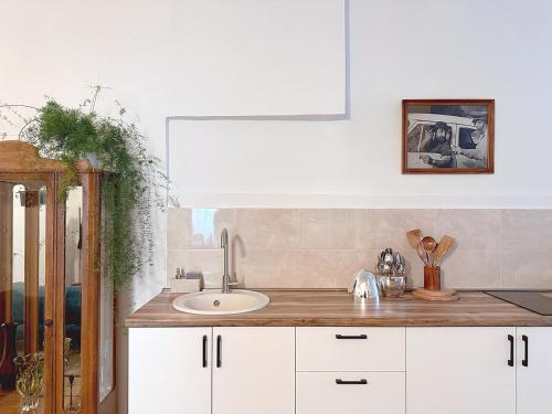 a kitchen with white cabinets and a sink at Your Cascade Home: In Yerevan Heart in Yerevan