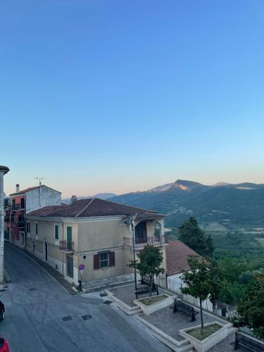 a city street with buildings and mountains in the background at Residenza del Castello di Fornelli in Fornelli