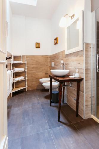 a bathroom with a sink and two toilets at Villa Francesca Luxury - Adriatic Nature & Heritage House in Grottammare