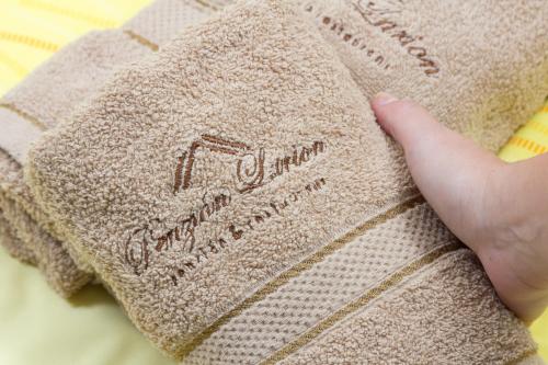 a persons hand is holding a pillow with a towel at Penzion Larion in Kráľová Lehota
