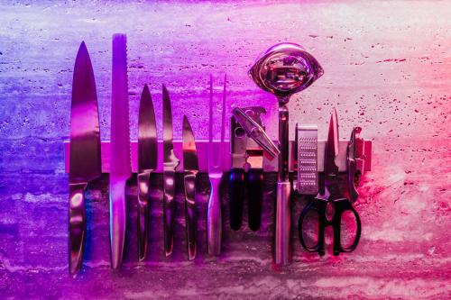 a bunch of knives sitting on top of a table at OBO Casa • Modern Lux Design Loft • Ipanema Beach in Rio de Janeiro