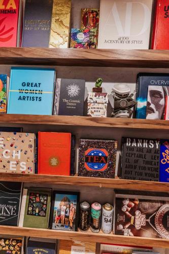 a shelf with books and other items on it at OBO Casa • Modern Lux Design Loft • Ipanema Beach in Rio de Janeiro