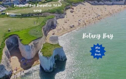 an aerial view of a beach with people on the sand at Beach Retreat Cottage- huge Garden Child & Dog friendly in Broadstairs