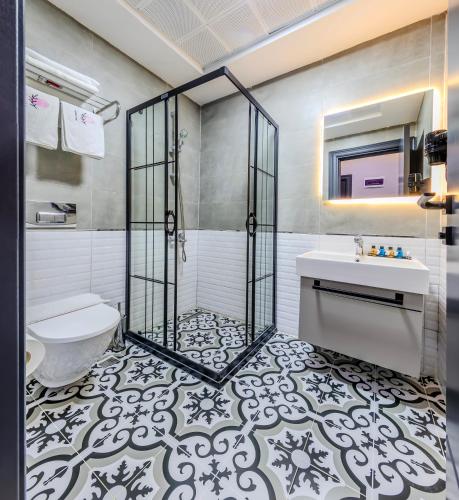 a bathroom with a shower and a toilet and a sink at Intercity Hotel Istanbul Airport in Arnavutköy