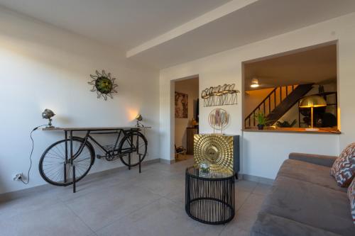 a living room with a bike hanging on the wall at Maison Cosy in Saint-Denis