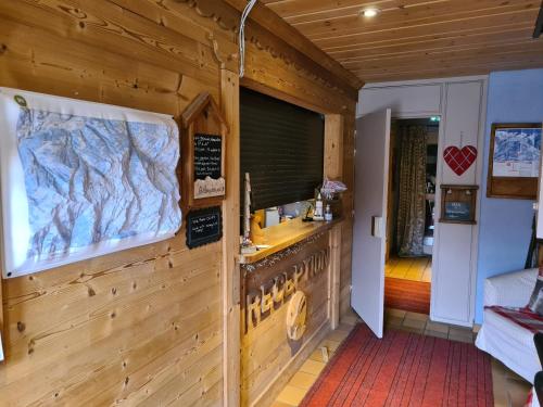a room with a wooden wall with a counter at Hôtel et Appart'Hôtel Restaurant L'Adray in Longefoy