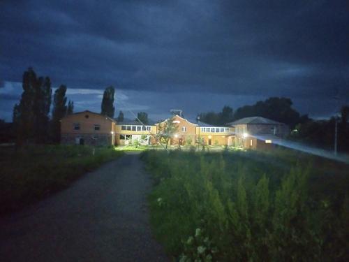 a house lit up at night in a field at Sevan Backstage Garden in Sevan