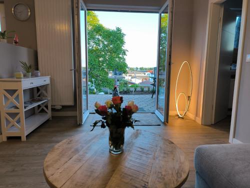 a vase of flowers on a table in a living room at Ferienwohnung Sonnenschein in Ostseebad Sellin