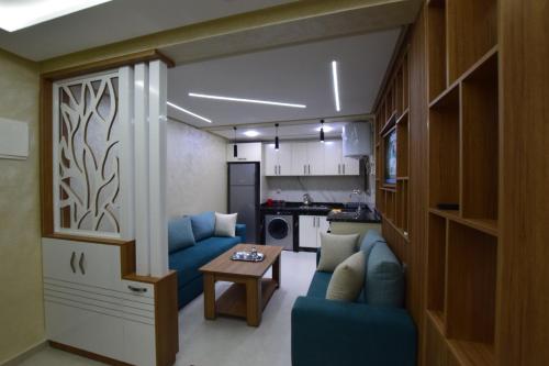 Posezení v ubytování Appartement familial proche aéroport et Oasiria