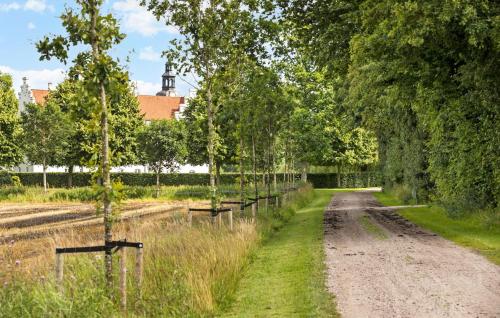 a dirt road with trees in a field at Gorgeous Home In Glesborg in Glesborg