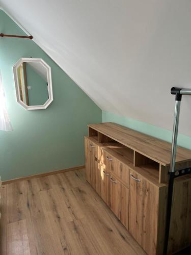 a room with a mirror on the wall and a staircase at Wooden house Ante self check - in and check - out in Otočac