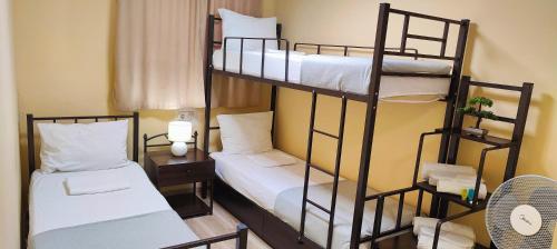 a room with two bunk beds and a desk at Light Hotel in Tbilisi City