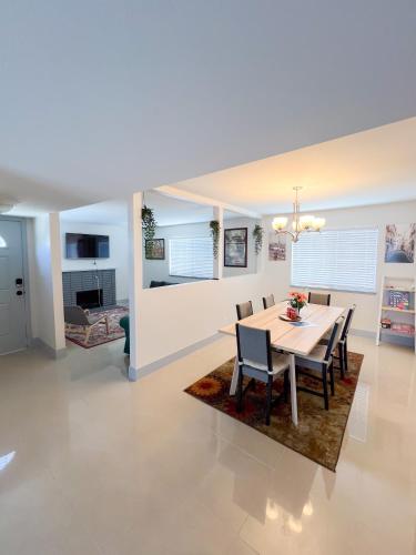 a dining room and living room with a table and chairs at Vegas Hideaway with Jacuzzi & Pool by Strip in Las Vegas