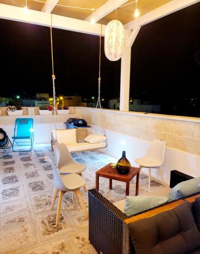 a living room with chairs and a couch and a table at Aquamarina Rooms in Porto Cesareo