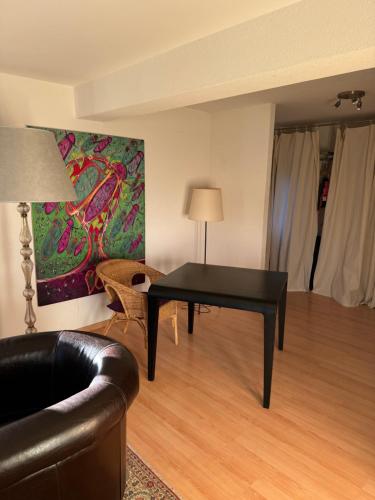 a living room with a black table and a couch at Chalet Alouette in Evolène