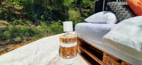 a table with a candle on top of a bed at La Bulle d'Haut in Wiesenbach