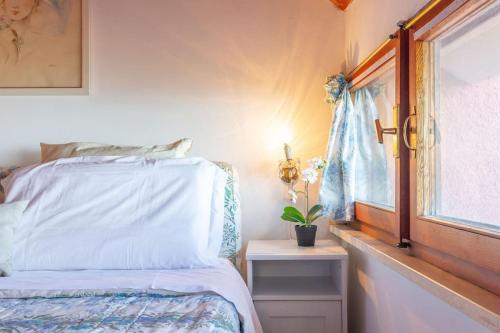 a bedroom with a white bed and a window at Chalet Aria Sottile in Sassotetto