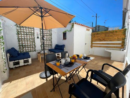 a patio with an umbrella and a table and chairs at Calo's Place in Fisterra