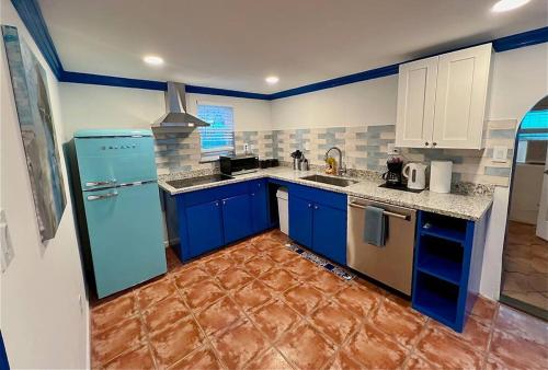 a kitchen with blue cabinets and a blue refrigerator at Elegant 1BR Montrose - Napoli The Italian Plaza in Houston