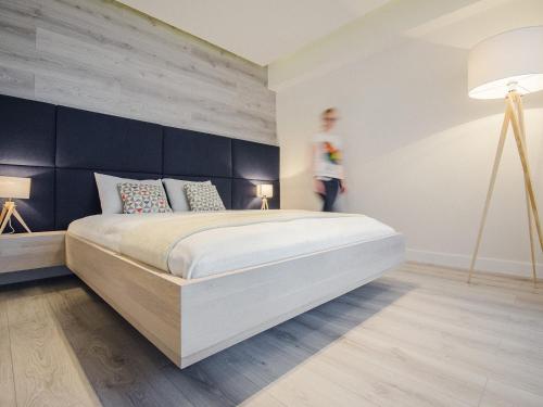 Ένα ή περισσότερα κρεβάτια σε δωμάτιο στο Ataner Apartamenty