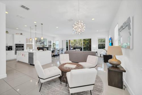 a kitchen and living room with a table and chairs at The Carpe Diem in Orlando