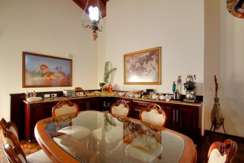 a dining room with a glass table and chairs at St. Lucia Wetlands Guest House in St Lucia