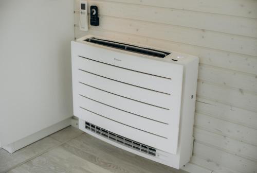 a white filing cabinet in a corner of a room at Fairytale Guest House & SPA in Jaunkrimulda