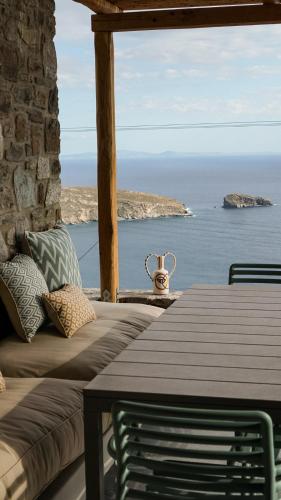 a room with a table and a view of the ocean at Serene Shore Serifos in Alona