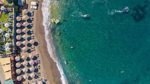 an overhead view of a beach with umbrellas and the ocean at AKASHA Beach Hotel & Spa in Hersonissos