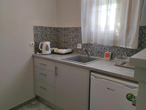 a kitchen with a sink and a counter top at Lefki Studios in Lakithra