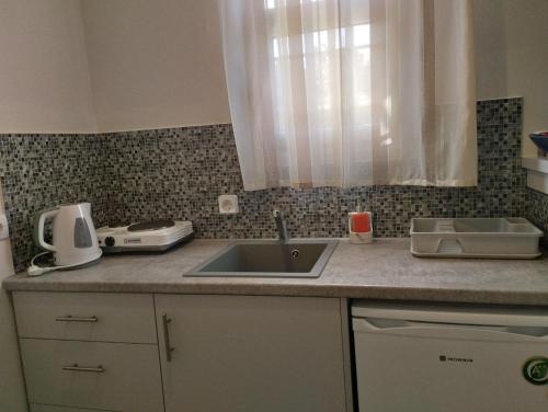 a kitchen counter with a sink and a window at Lefki Studios in Lakithra