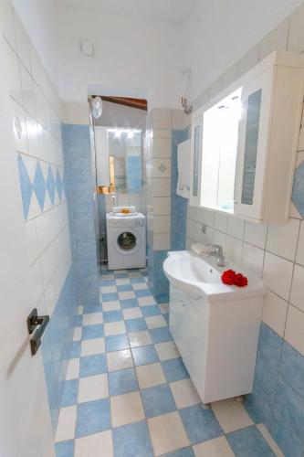 a bathroom with a sink and a washing machine at ELIZABETH by Antigone in Halikounas