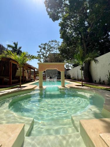 a swimming pool with a gazebo at Historic House Hotel boutique in Mérida