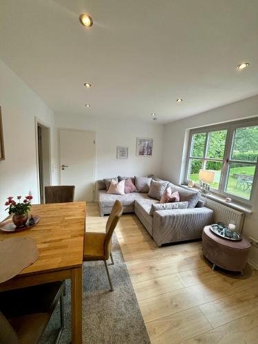 a living room with a couch and a table at Balance Apartments by M&A - Family Apartment Ferienhaus Dohrenbach in Witzenhausen