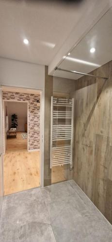 an empty room with a room with a stone wall at Renatas Ferienwohnung ISABEL in Sasbachwalden