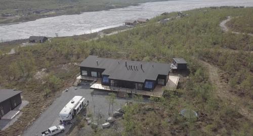 an aerial view of a house next to the water at Aurora View Lapland, Sky View Bedroom & Jacuzzi in Kilpisjärvi