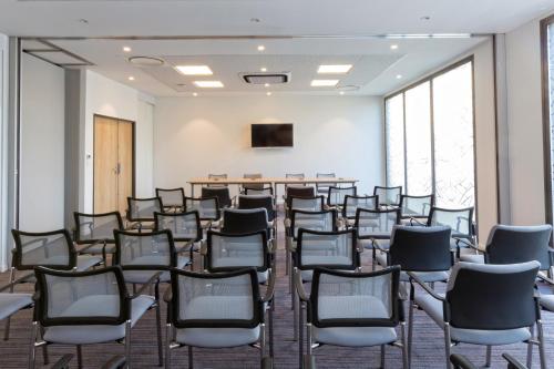 an empty room with chairs and a podium at All Suites Appart Hôtel - Bordeaux - Pessac in Pessac