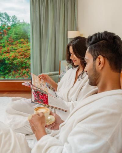 a group of people sitting in bed reading books at Hyatt Pune in Pune