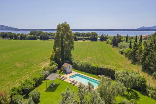 an aerial view of a large field with a house and a swimming pool at Chalet Vignarola - Happy Rentals in Orbetello