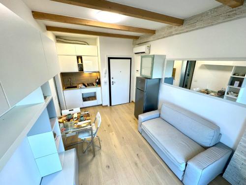 a living room with a couch and a table at Appartamento Rimini Chanel in Rimini