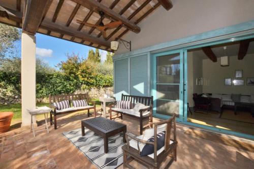 a patio with two benches and a table at Chalet Vignarola - Happy Rentals in Orbetello