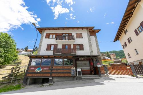 a building with a balcony on top of it at Miramonti 21 Ski In - Ski Out - Happy Rentals in Sauze dʼOulx