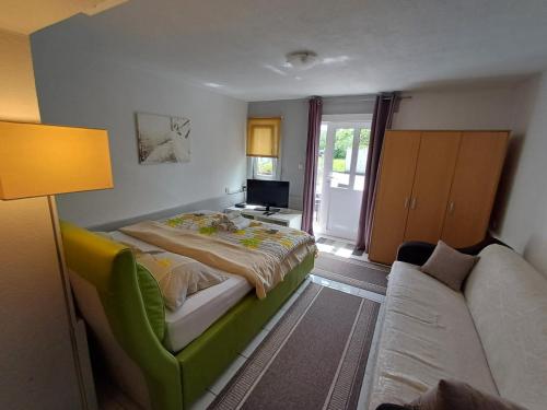a bedroom with a bed and a couch at Apartmani Župa in Tivat