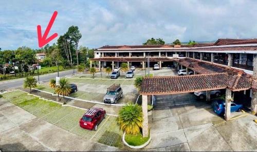 an image of a building with cars parked in a parking lot at Acogedor apartamento con hermosa vista al volcán - The Goat Spot - planta alta in Alto Boquete