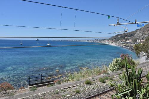 a view of the ocean from a hill with a bench at Holiday Home Gionny & Mary in Taormina