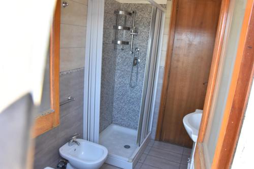 a bathroom with a shower and a toilet and a sink at Holiday Home Gionny & Mary in Taormina
